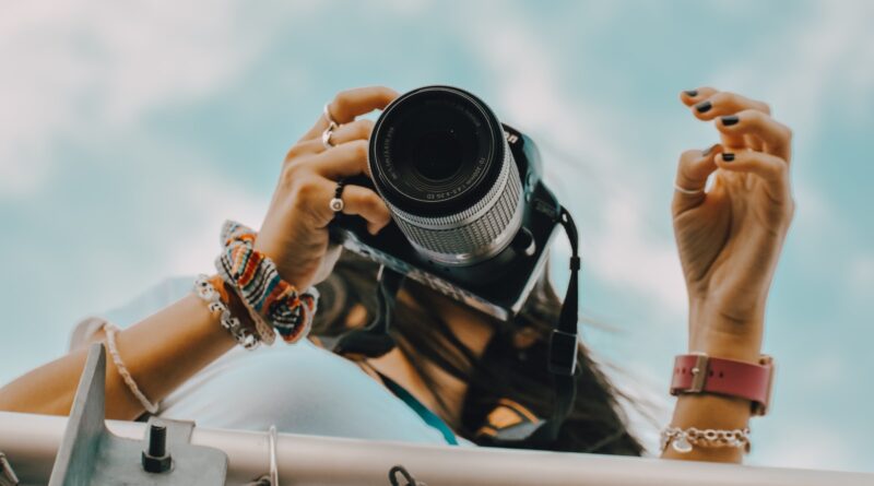 person holding black dslr camera